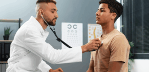 Médico realiza check-up em paciente durante atendimento, em referência ao Dia Mundial da Saúde e à importância da prevenção.